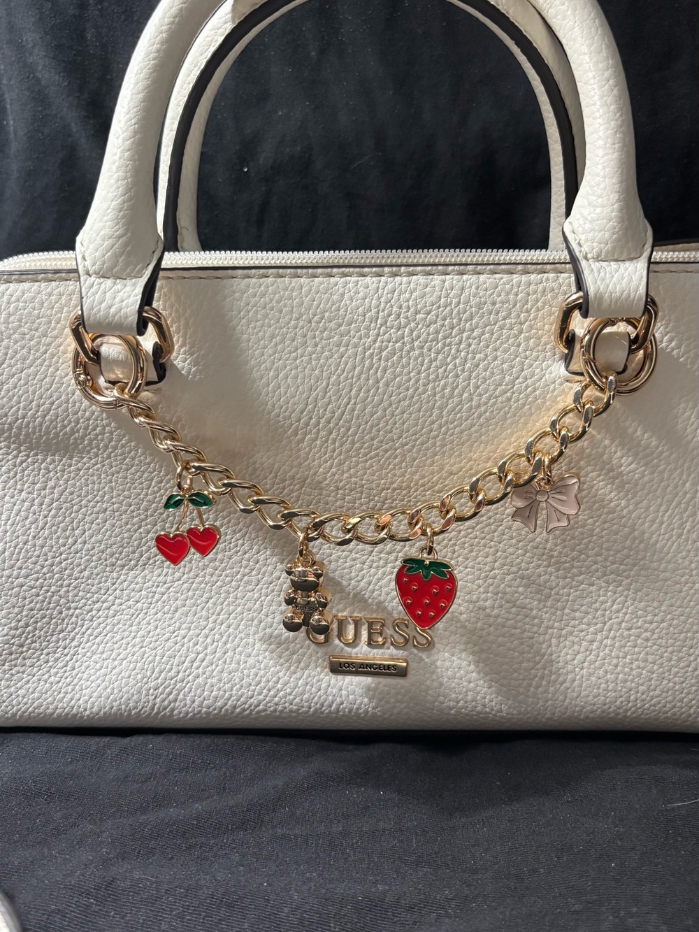 GUESS White Pebbled Satchel with Gold Charm Chain and Red Accents